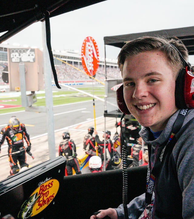 Caleb smiling at the racetrack