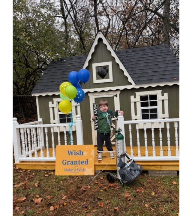 wish kid in front of playhouse
