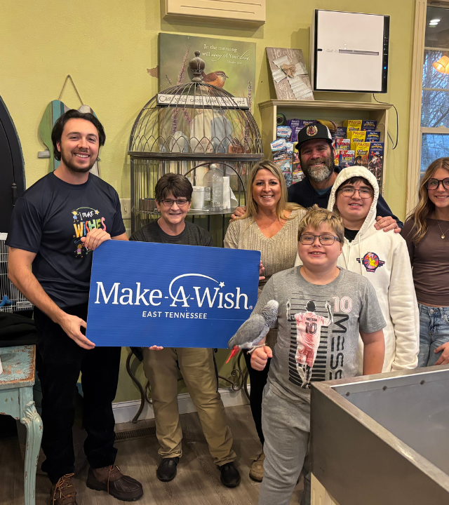 wish kid holding bird with family