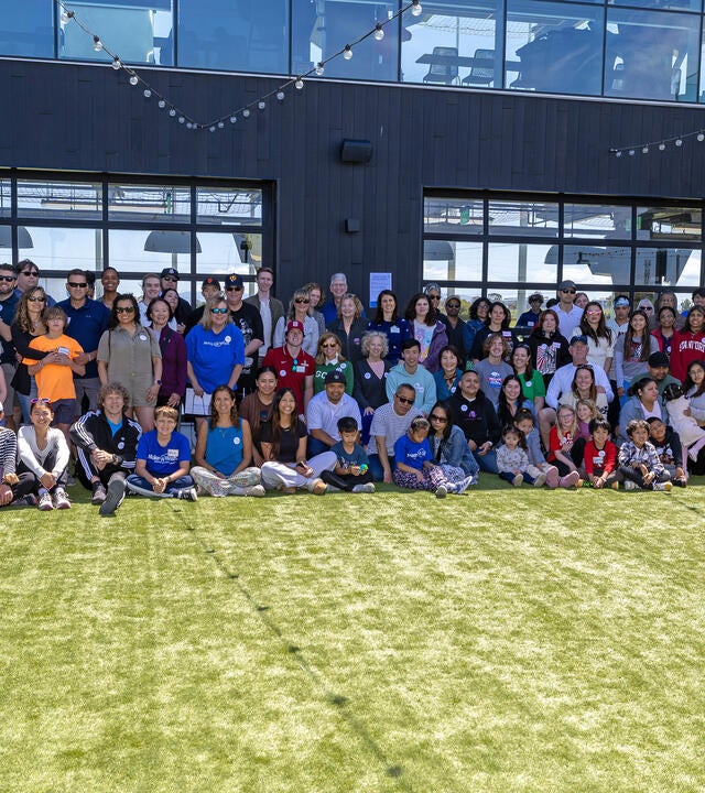 A large group of wish alumni and staff members at our Wish It Forward Reunion in 2024