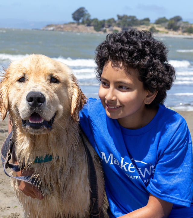 Anika poses joyfully with her new dog, Rudder. 