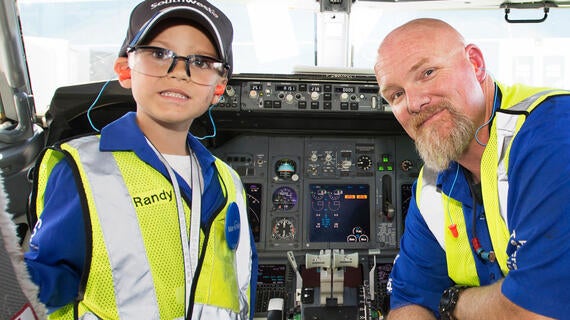wish kid Randy in a Southwest Airlines cockpit