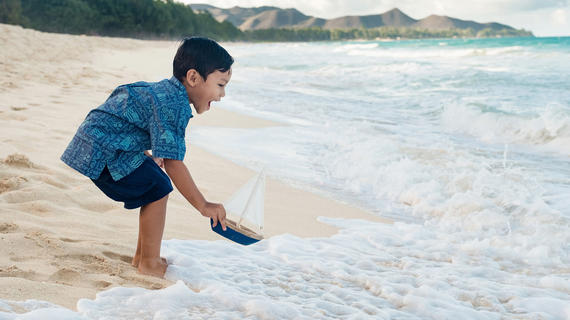 Wish kid Kanoa plays by the ocean