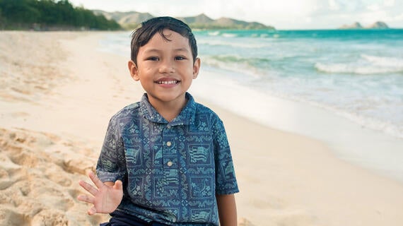 Wish kid Kanoa smiles at the beach