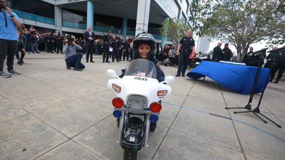 Liam on his motorcycle in front of police station
