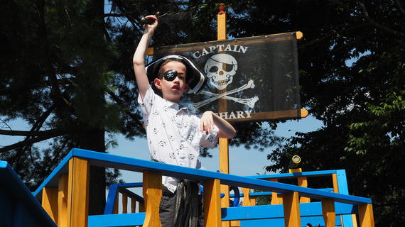 Zachary plays in his pirate playhouse dressed as a pirate