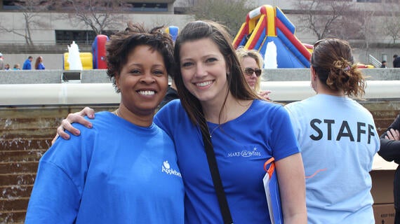 2 volunteers smiling
