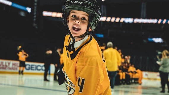 Asher smiling on the rink