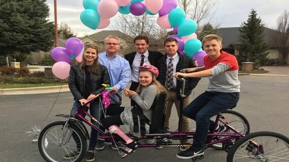 Brynn and family with new bicycle