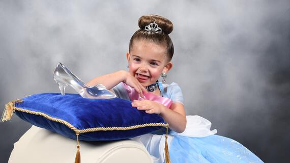 Caleigh poses with Cinderella's glass slipper.