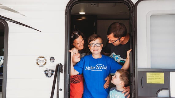 Ethan surrounded by his family in his new camper