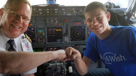 Wish kid fist bumps pilot