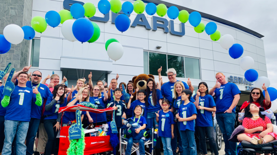 Rini celebrates her wish coming true with the team at Subaru.