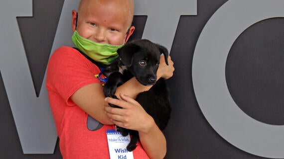Sawyer hugs Sparky and smiles
