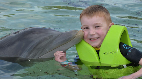 Alex in disney with dolphin