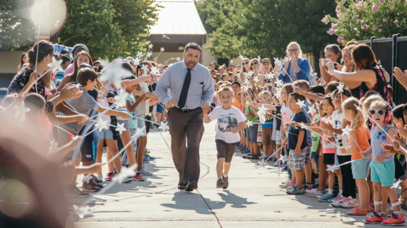 Wish Kid Ethan running through a crowd of onlookers 