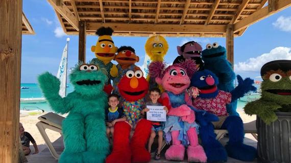 Jack and his brother sitting with sesame street characters