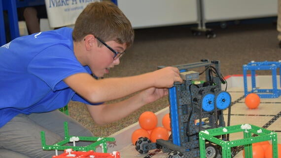 Joshua on the floor with his invention 