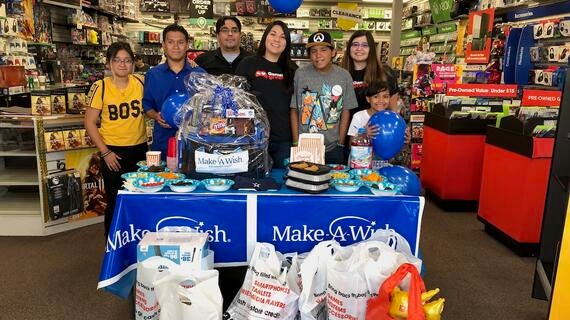 Juan with Gamestop employees at store