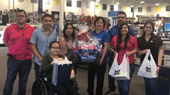 Magdiel with Best Buy employees and volunteer