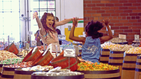 Wish Kid Makayla dances during her music video shoot with Wish Kid Jenna at a candy store