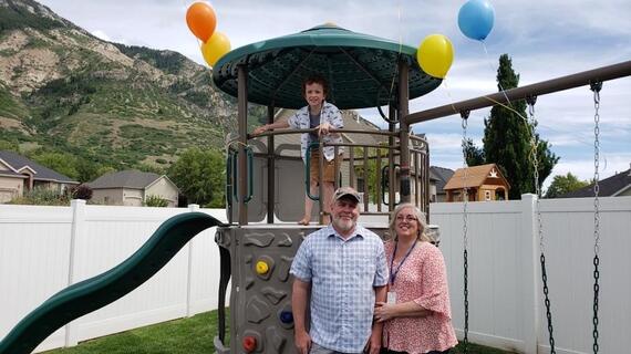Utah Volunteers and Wish kid with Playset