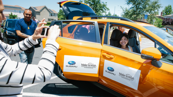 Wish kid Allayah in an orange Subaru Crosstrek
