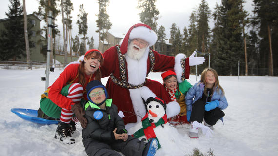 Santa with a wish family in the snow