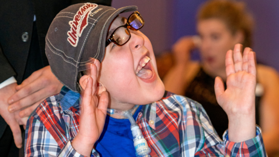 Wish kid Cole laughs during the story of his wish experience at Wish Ball 2020