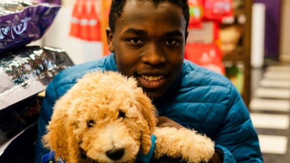 Kayleb holds his puppy Kevin