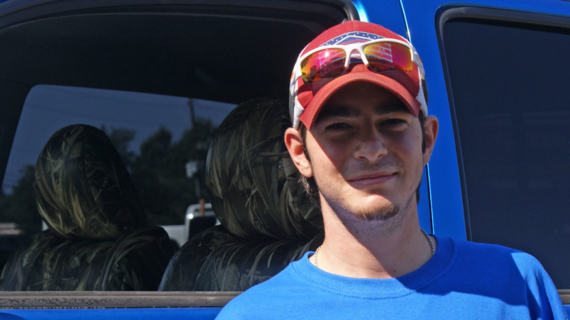 Michael smiles in front of his new truck.