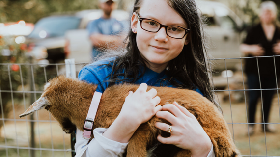 Madison hugs her one of her new pet goats, Mina