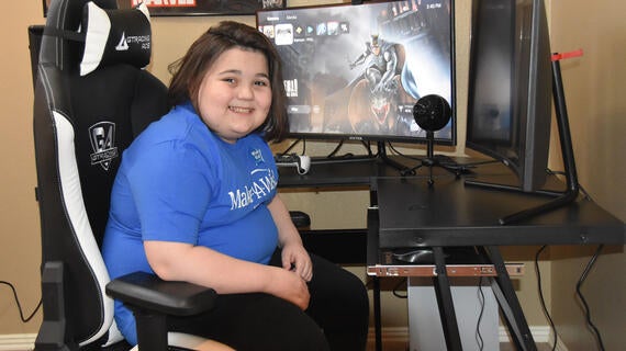 Wish kid Bryson enjoys a new computer gaming center.