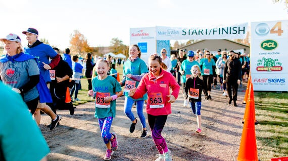 Kids running a race in front of the starting line
