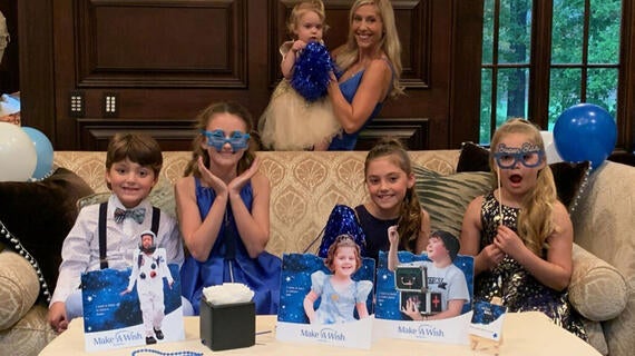 kids and woman enjoying party favors at wish ball