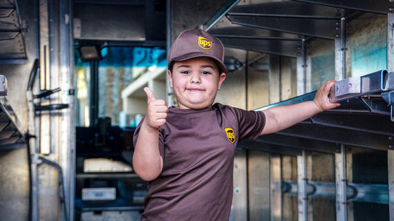 Mateo with a thumbs up inside a UPS Truck