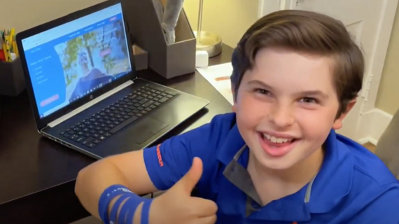 Wish kid Gavin smiles and gives a thumbs up