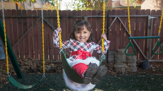 Alexa swinging on her playset