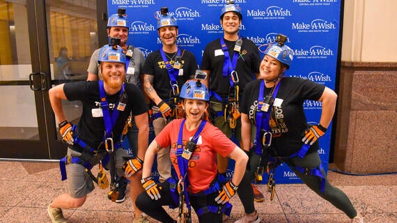 A group of rappellers from Torchy's Tacos
