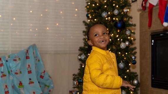 Aayden explores his gifts under his Christmas tree!