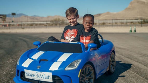 Gerold and his brother in mini racecar