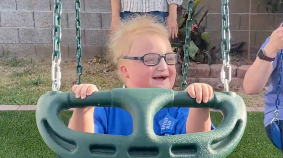 Wesley laughing on his playset.
