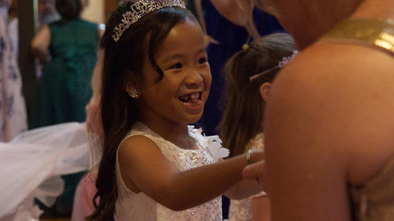 Journi wearing a princess gown and tiara dancing at her ball