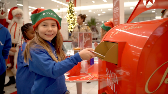 Child submitting their letter to Santa at Macy's
