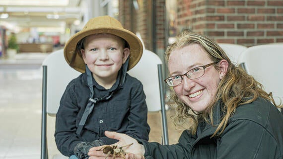 Brayden and an animal handler with a tarantula