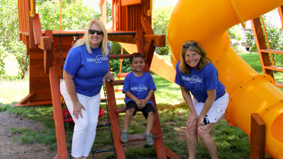 Volunteer wish granters Diane and Janice at wish kid Parker's wish for a playset