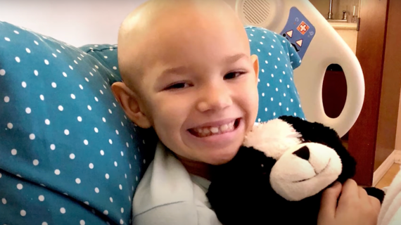 Wish kid Nyla with stuffed dog in hospital