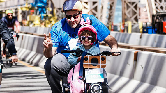 Father and daughter riding bike in bike tour