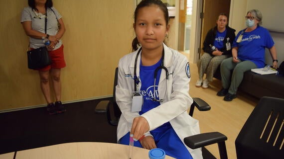 Melanie after her simulation surgery with the gallstone and gallbladder props she removed.