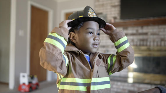 Wish kid in fireman coat and hat